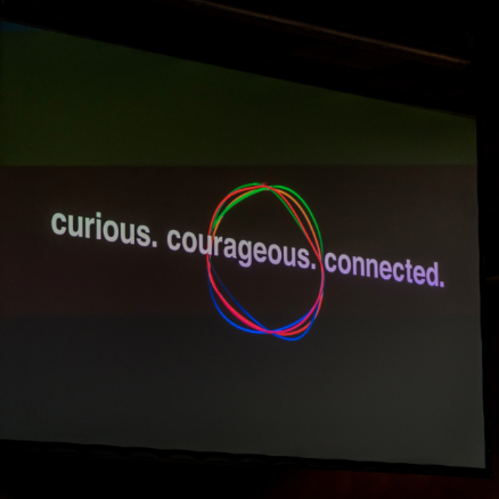 UBS workshop — 'curious. courageous. connected.' projected on screen.